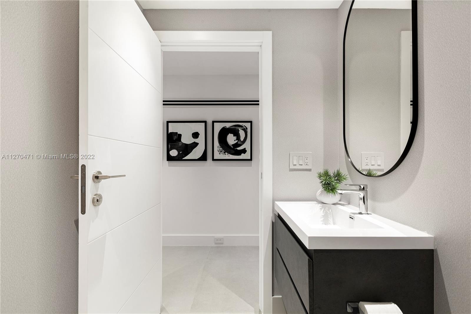 4095 Battersea Road Miami, FL 33133 - Photo 30 of 40 a bathroom with a sink and a mirror