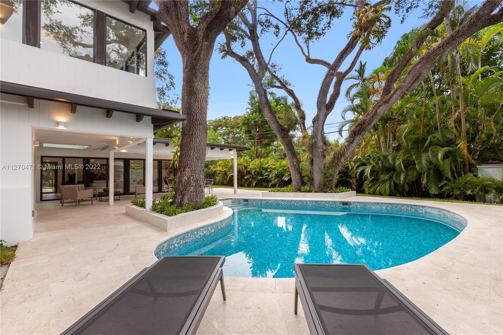 4095 Battersea Road Miami, FL 33133 - Photo 33 of 40 a view of a swimming pool with a patio