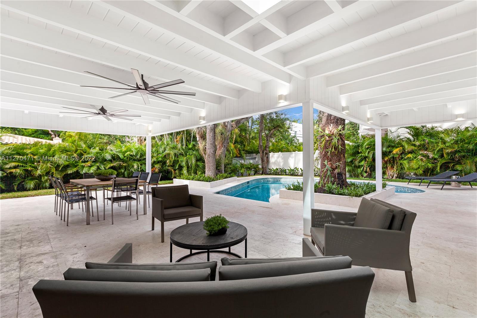 4095 Battersea Road Miami, FL 33133 - Photo 34 of 40 a living room with patio furniture and a large window