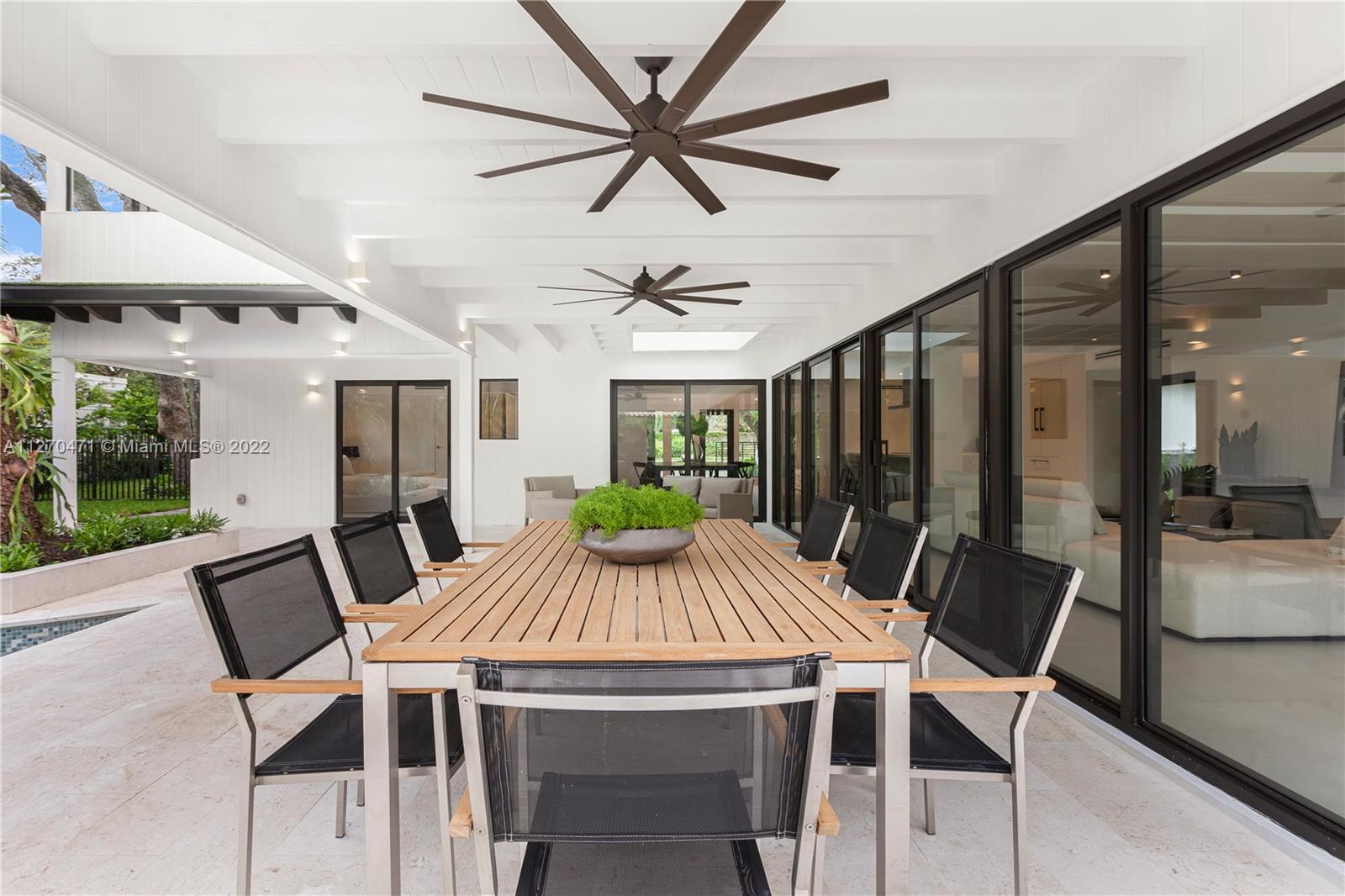 4095 Battersea Road Miami, FL 33133 - Photo 35 of 40 a view of a dining room with furniture window and wooden floor