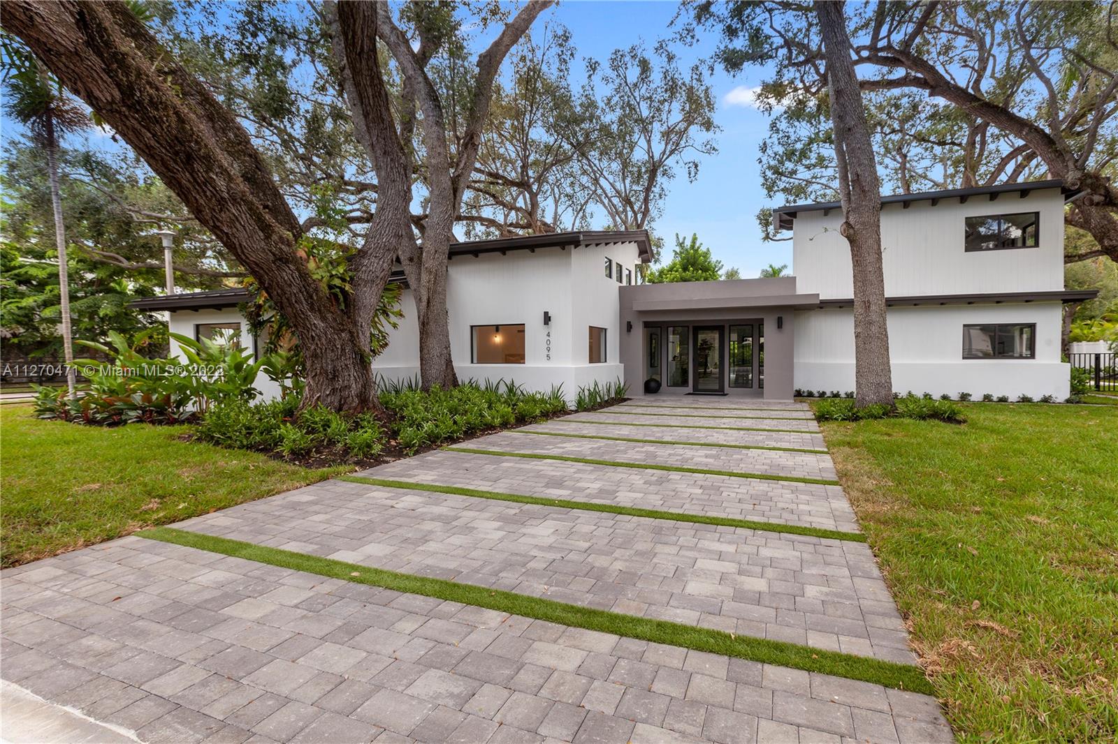 4095 Battersea Road Miami, FL 33133 - Photo 37 of 40 a front view of a house with garden