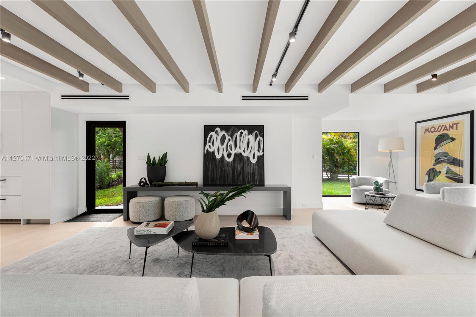 4095 Battersea Road Miami, FL 33133 - Photo 4 of 40 a living room with furniture and a large window