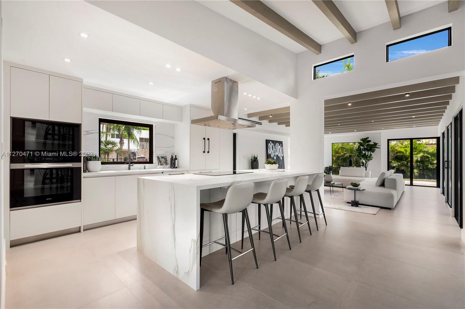 4095 Battersea Road Miami, FL 33133 - Photo 6 of 40 a living room with furniture a large window and a flat screen tv