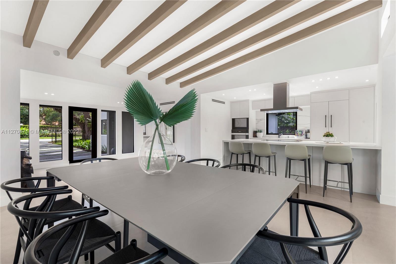 4095 Battersea Road Miami, FL 33133 - Photo 9 of 40 a dining room with furniture and window