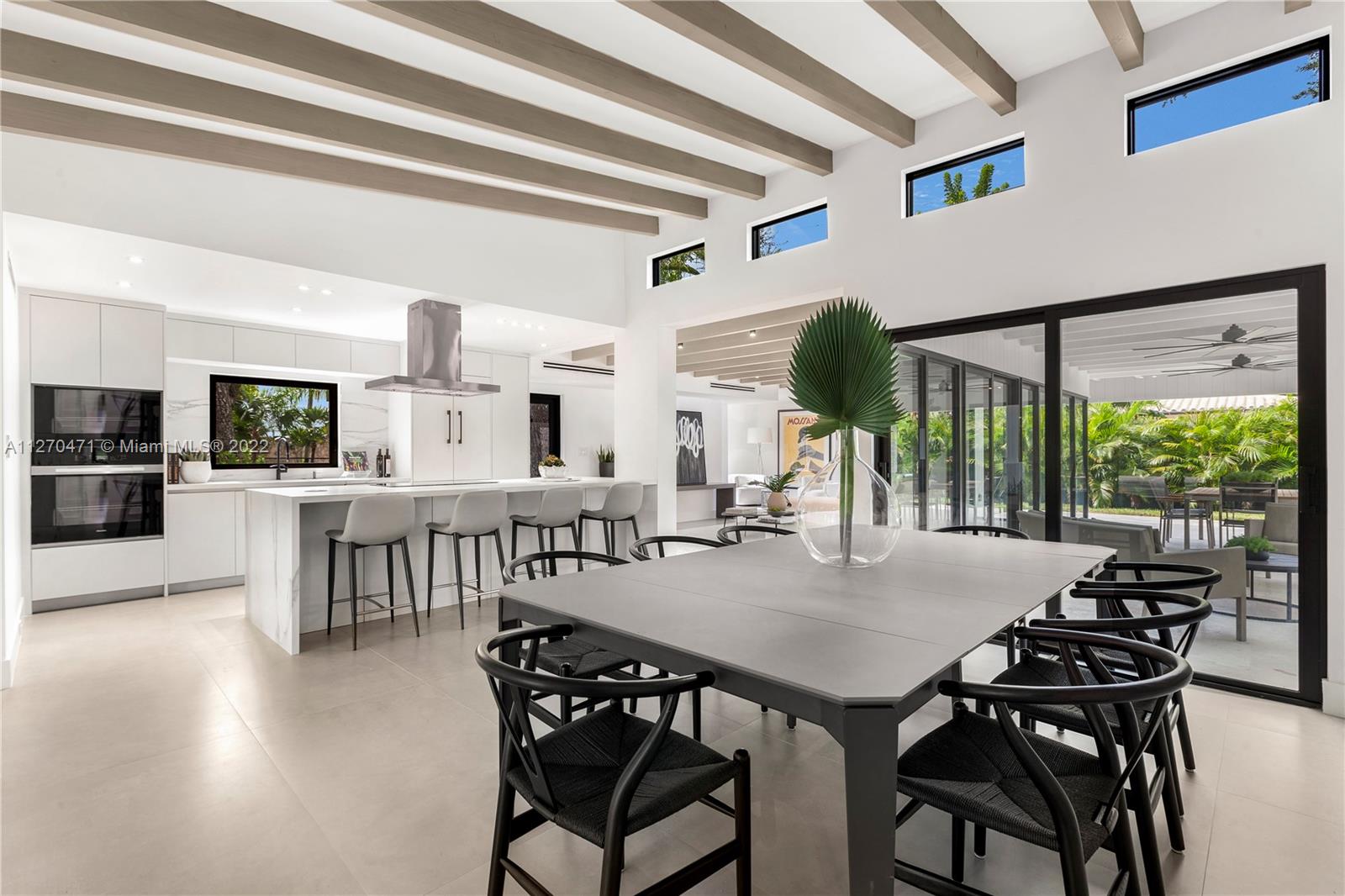 4095 Battersea Road Miami, FL 33133 - Photo 10 of 40 a view of a dining room with furniture window and wooden floor