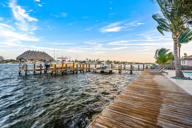 a view of a parking space with lots of chairs and umbrellas