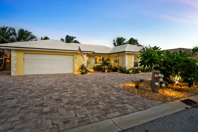 a view of swimming pool with outdoor seating and trees in the background