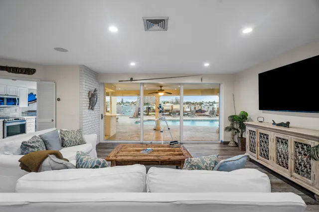 a kitchen with stainless steel appliances granite countertop a refrigerator a stove a sink and a microwave