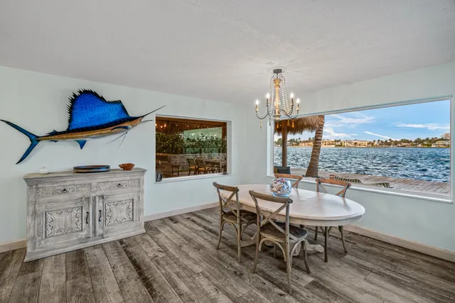a kitchen with stainless steel appliances kitchen island granite countertop a refrigerator and a sink