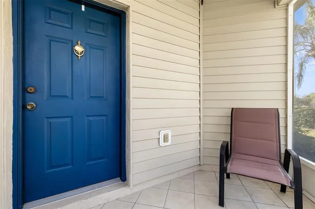 a living room with furniture and a glass door shower