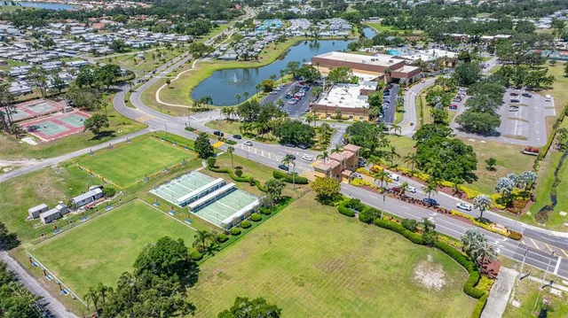 an aerial view of a pool yard and mountain view in back