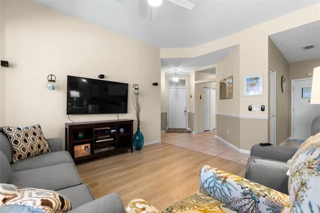 a kitchen with stainless steel appliances kitchen island a refrigerator sink and cabinets
