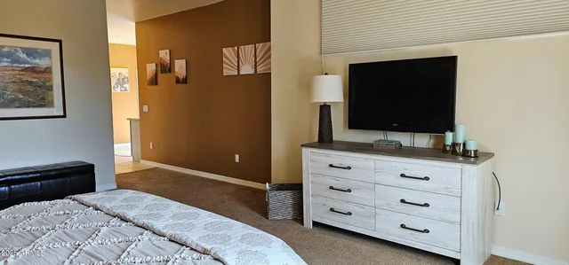 a bedroom with a bed and a flat screen tv