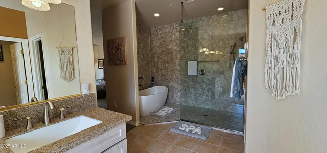 a bathroom with a granite countertop sink a toilet and shower