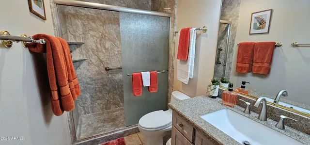 a bathroom with a sink toilet and shower