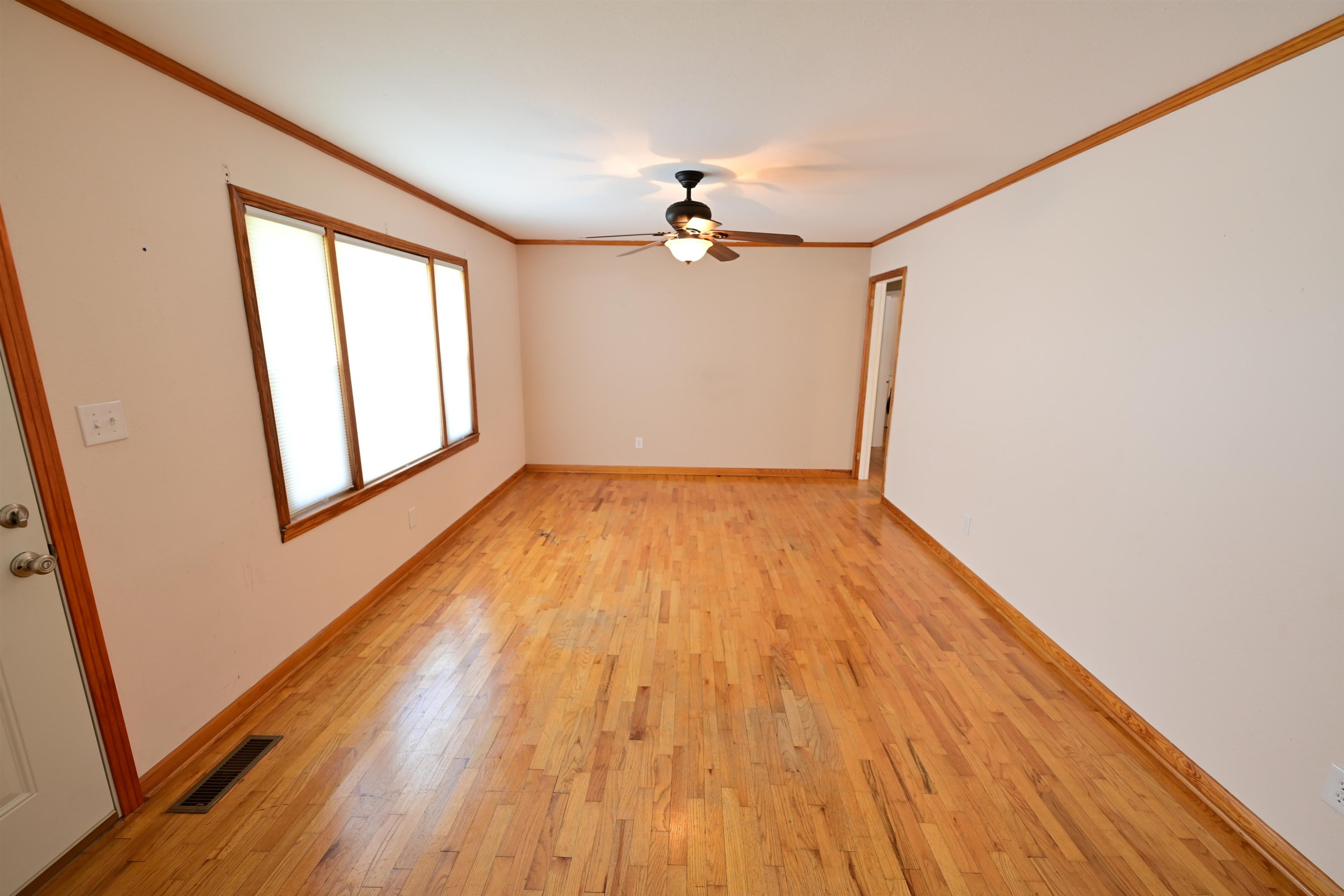 61 Johnny Dodd Road Newbern, TN 38059 - Photo 4 of 15 a view of empty room with wooden floor and fan