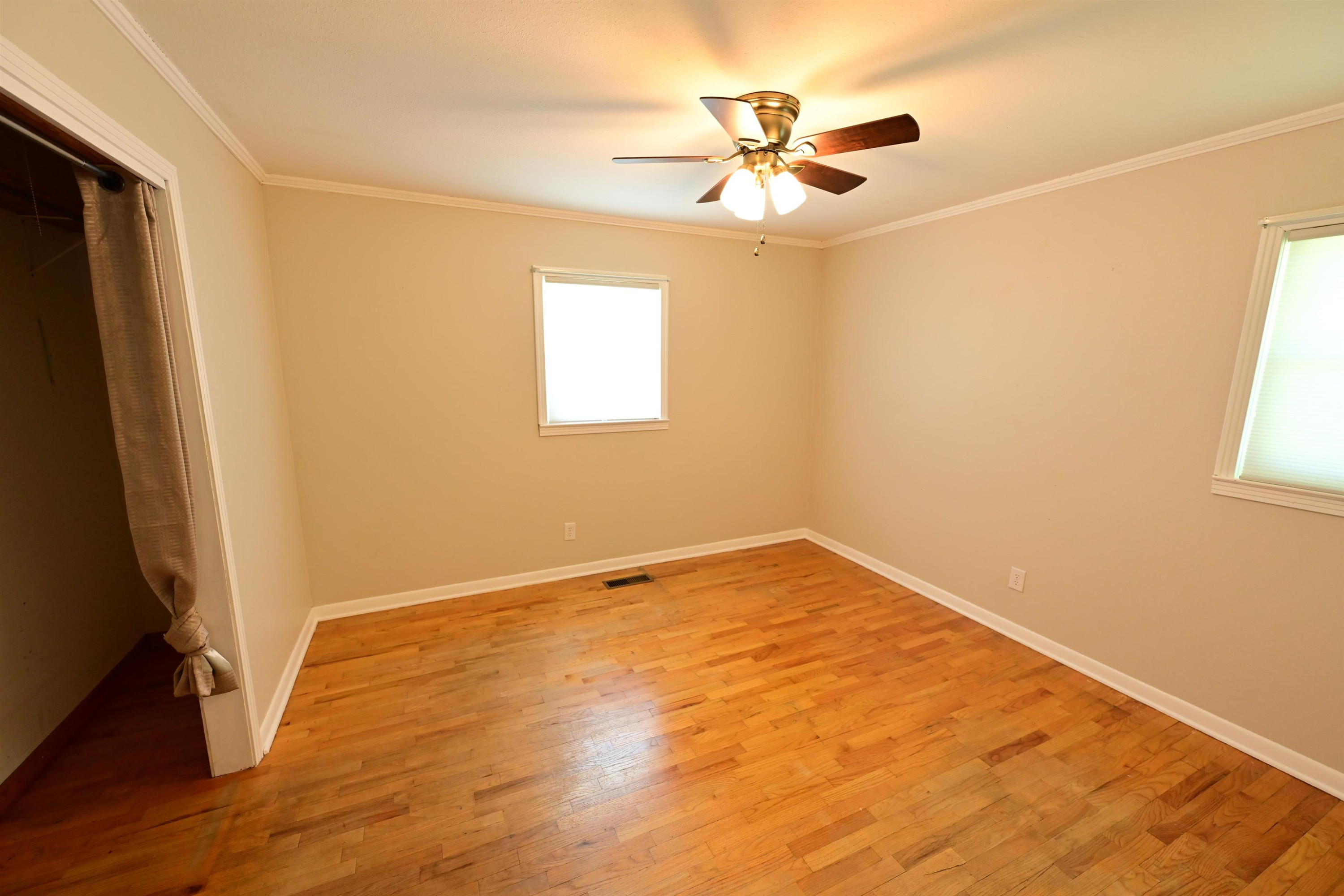 61 Johnny Dodd Road Newbern, TN 38059 - Photo 6 of 15 a view of an empty room with wooden floor and a window