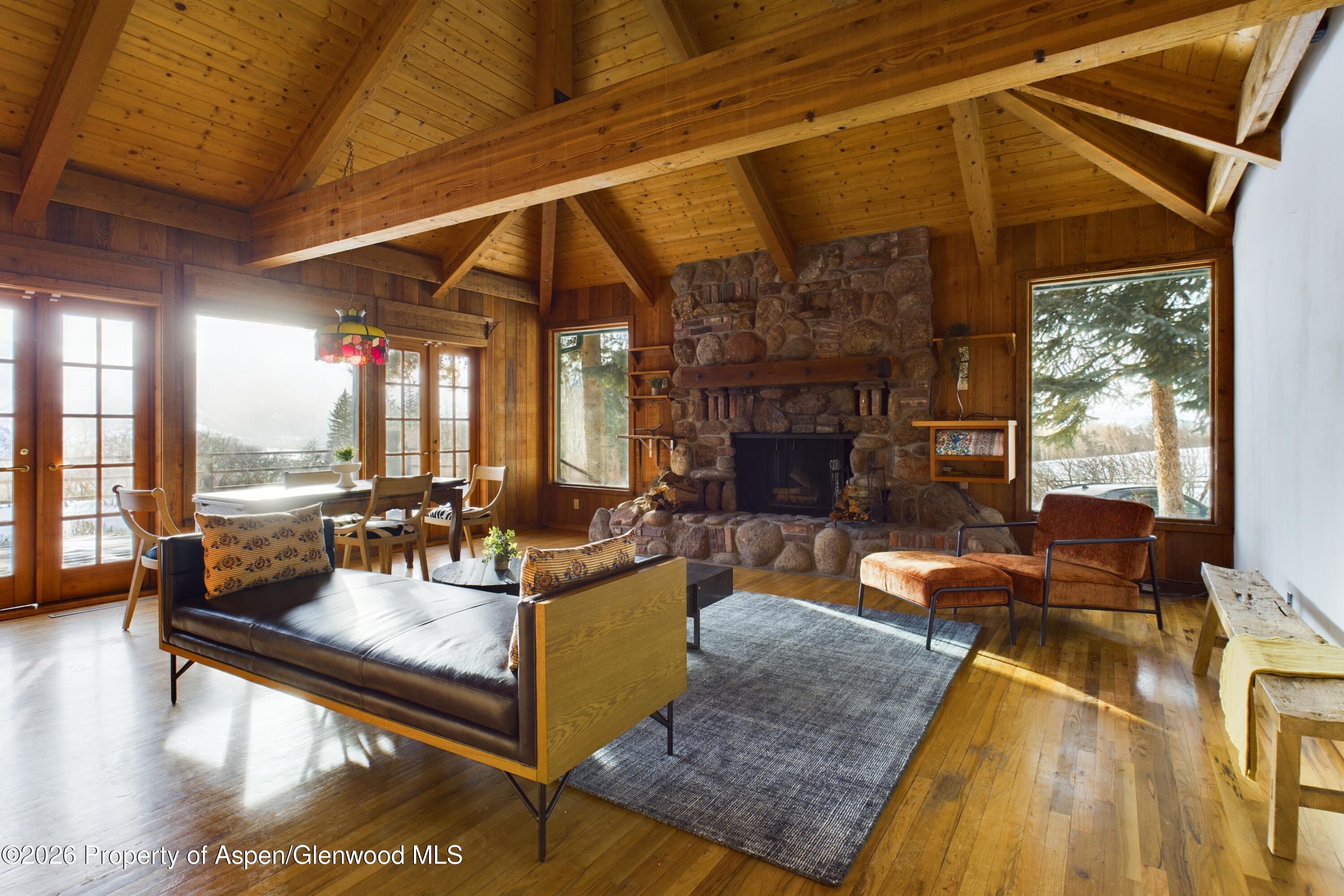 209 East Reds Road Aspen, CO 81612 - Photo 12 of 54 a living room with fireplace furniture and a large window