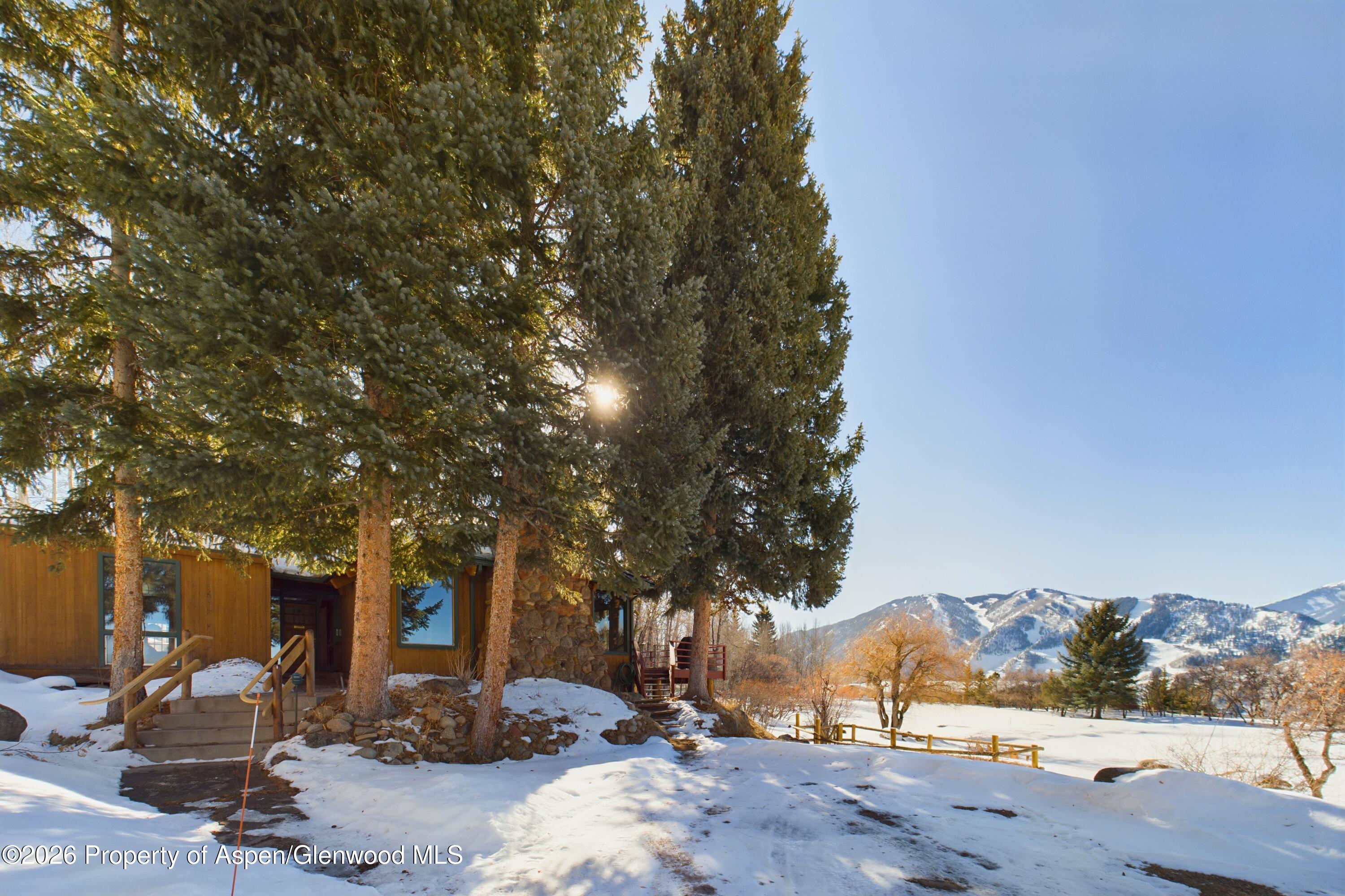 209 East Reds Road Aspen, CO 81612 - Photo 3 of 54 a front view of a house with a yard