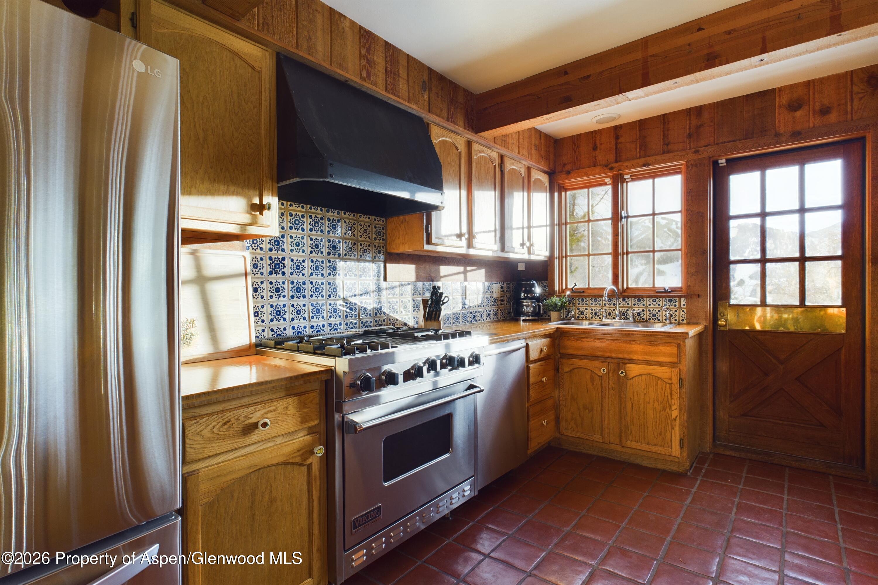 209 East Reds Road Aspen, CO 81612 - Photo 31 of 54 a kitchen with stainless steel appliances granite countertop a stove a sink and a refrigerator