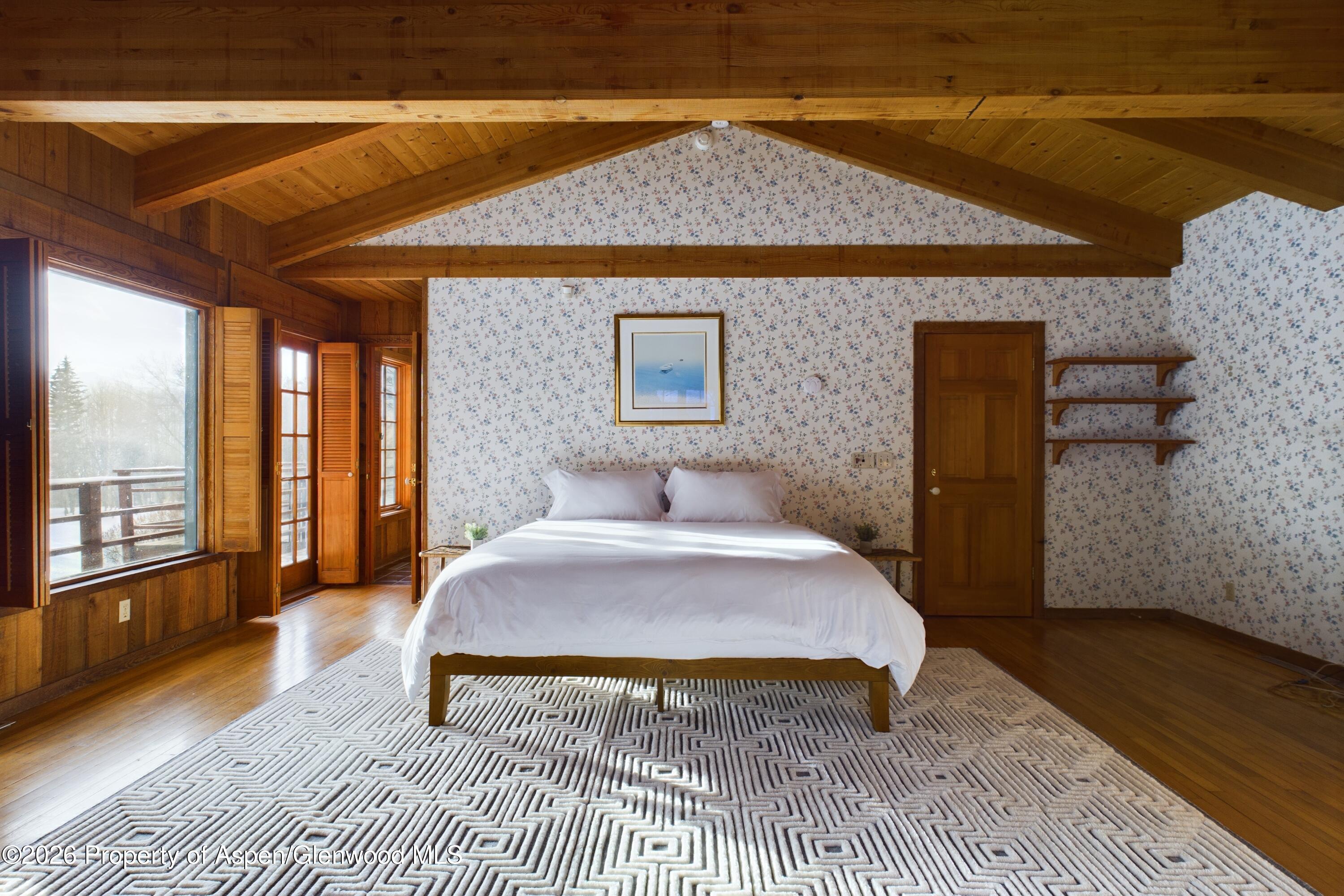 209 East Reds Road Aspen, CO 81612 - Photo 33 of 54 a bedroom with a bed and wooden floor