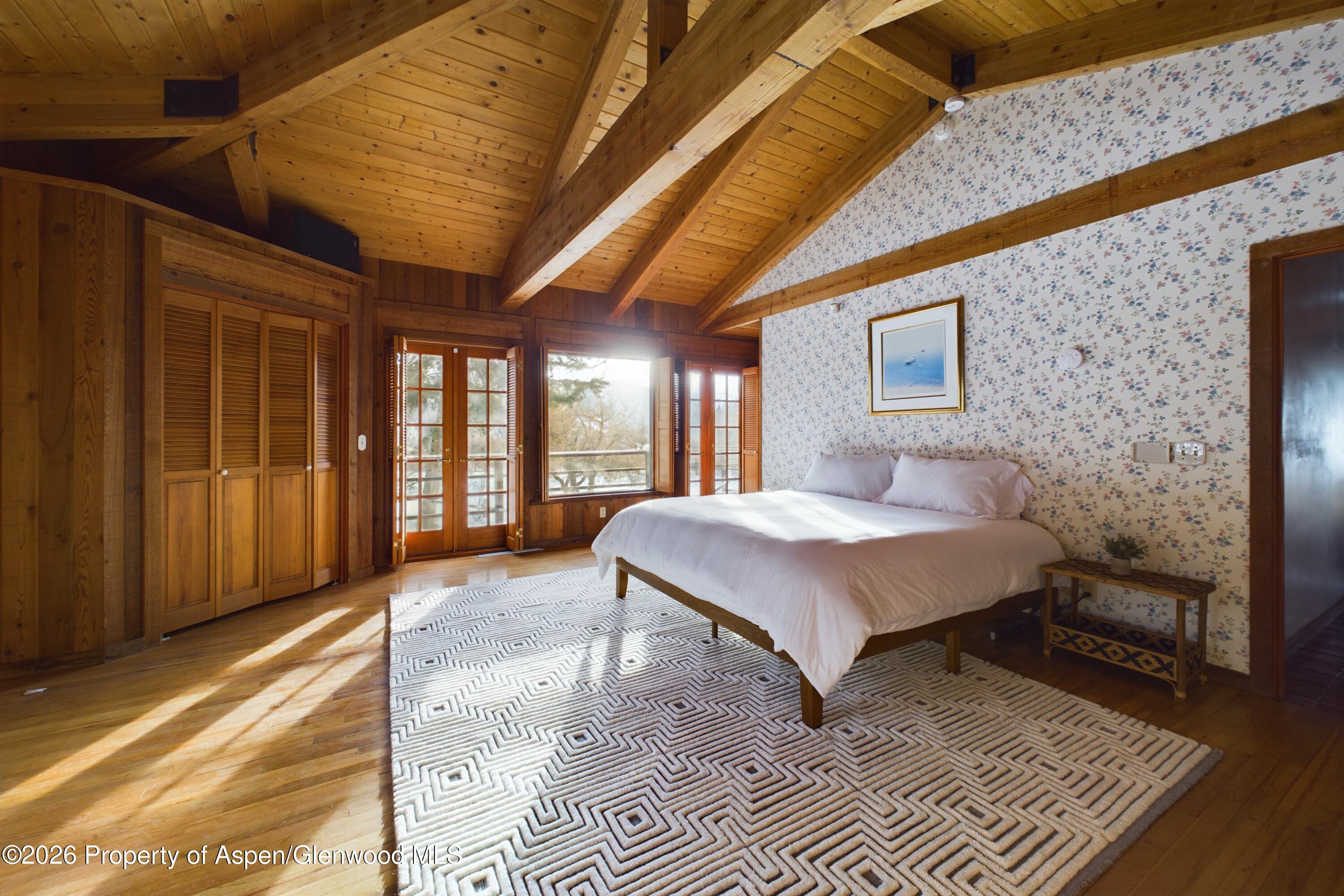 209 East Reds Road Aspen, CO 81612 - Photo 35 of 54 a bed sitting in a spacious bedroom next to a window