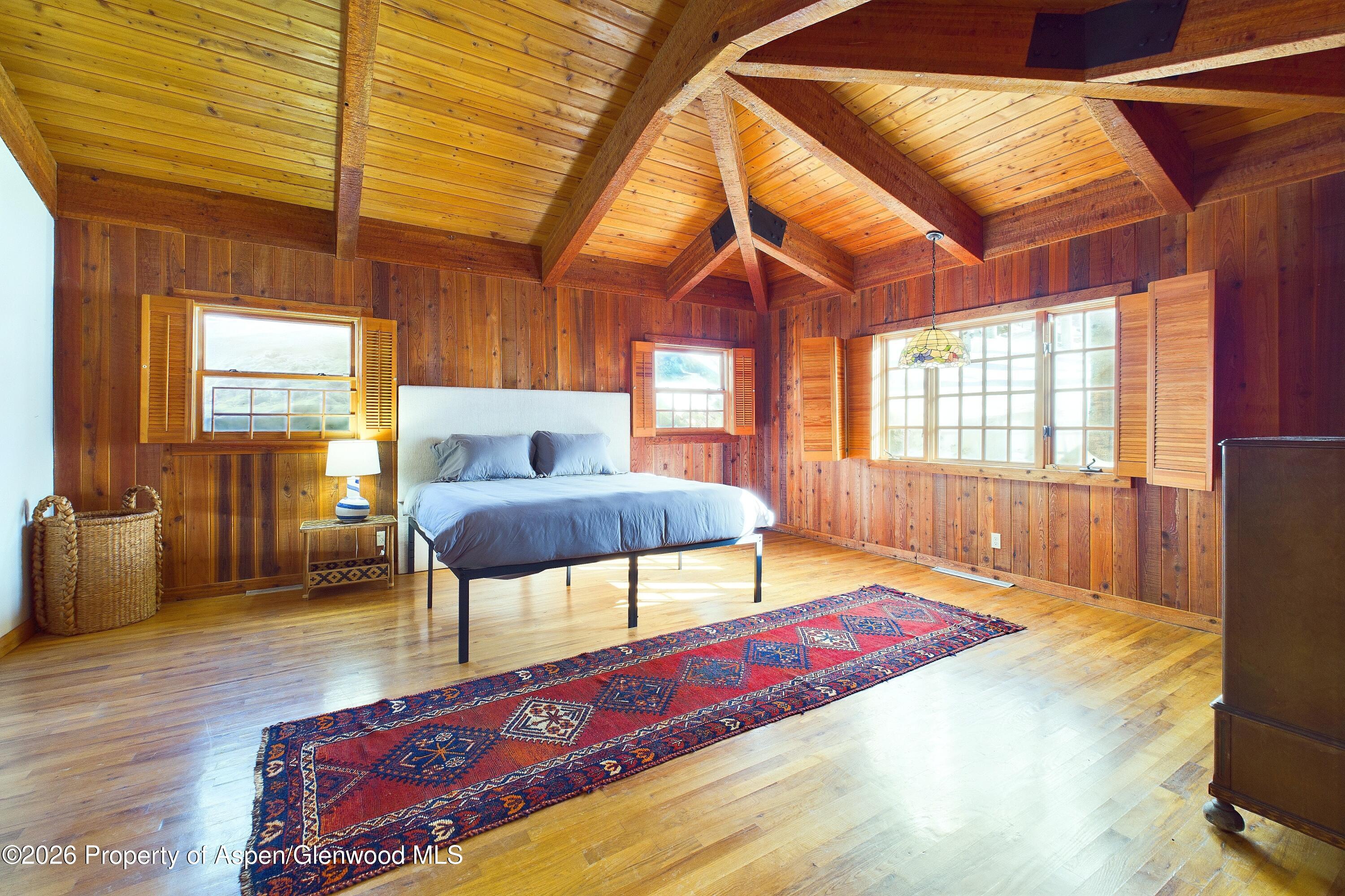 209 East Reds Road Aspen, CO 81612 - Photo 39 of 54 a bedroom with furniture and a wooden floor