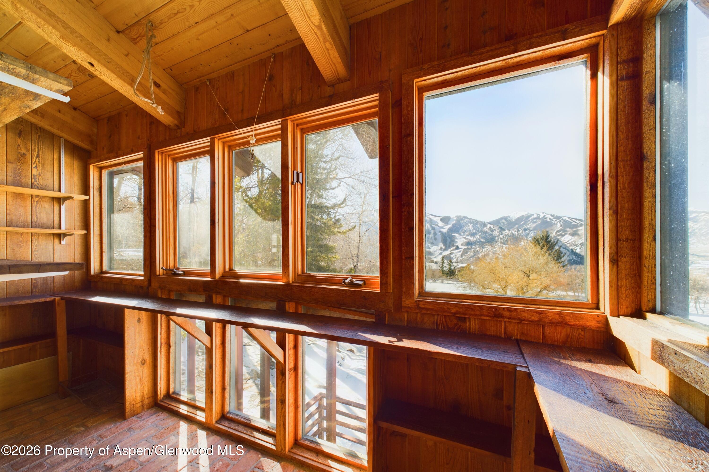 209 East Reds Road Aspen, CO 81612 - Photo 49 of 54 a view of an empty room with wooden floor and windows