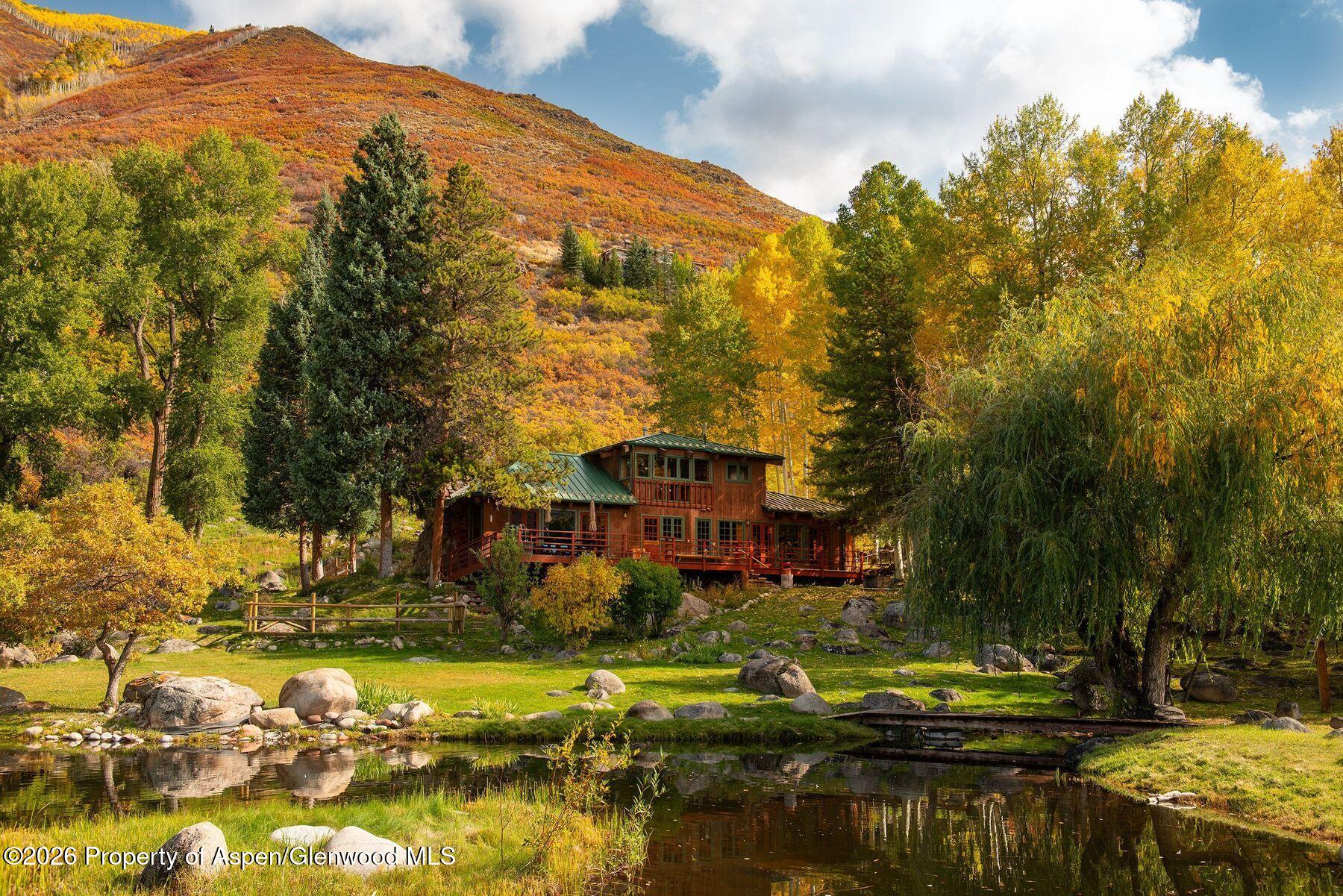 209 East Reds Road Aspen, CO 81612 - Photo 7 of 54 a view of a lake with a house in the background