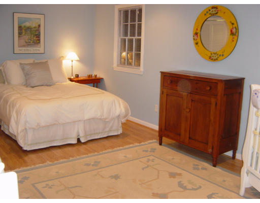 3 Harvard Road Framingham, MA 01701 - Photo 9 of 12 a bedroom with a bed and a painting on the wall