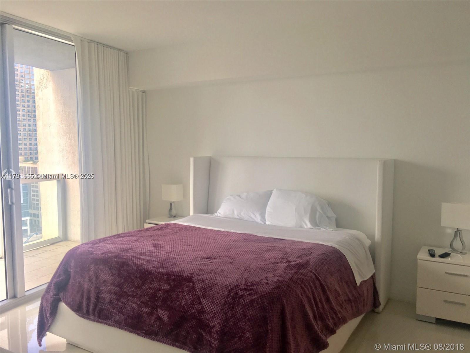 485 Brickell Avenue, Unit 1903 Miami, FL 33131 - Photo 6 of 8 a bedroom with a bed and a window