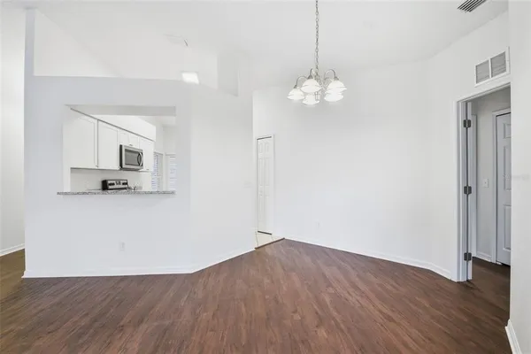 a view of kitchen with granite countertop cabinets and wooden floor