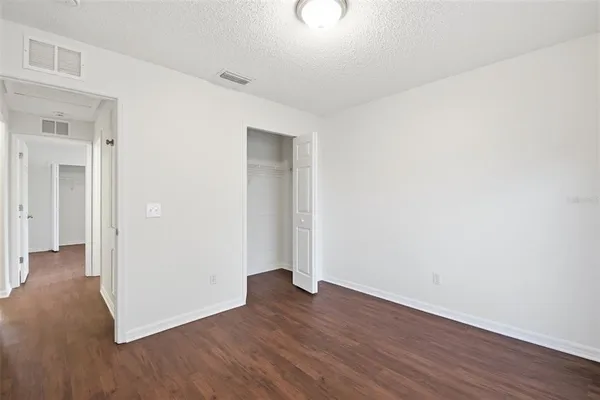an empty room with wooden floor
