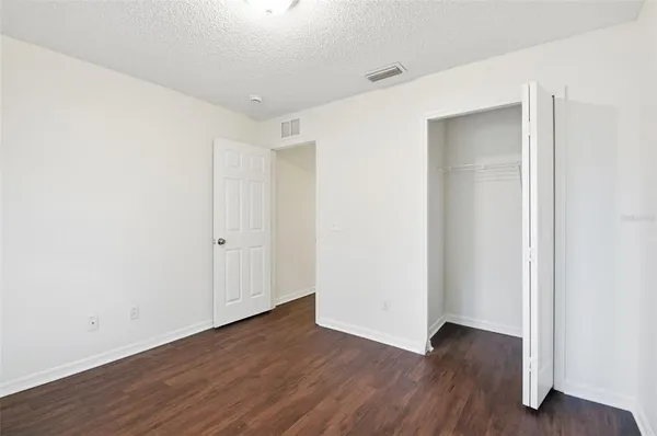 a view of a room with wooden floor