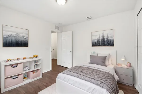 a bedroom with furniture and flat screen tv