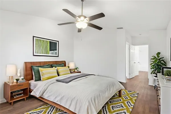 a bedroom with a bed and a chandelier
