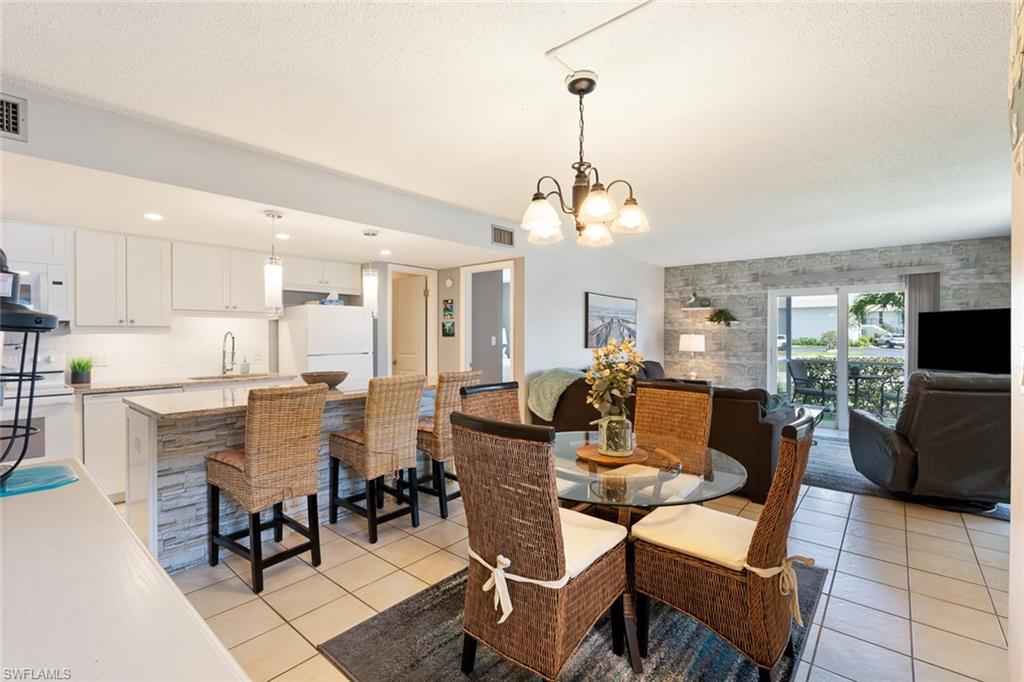 240 Palm Drive, Unit 481 Naples, FL 34112 - Photo 1 of 17 a view of a dining room with furniture