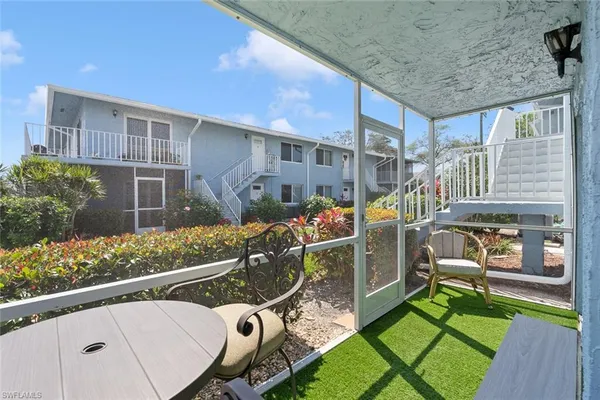 a view of a house with backyard and sitting area