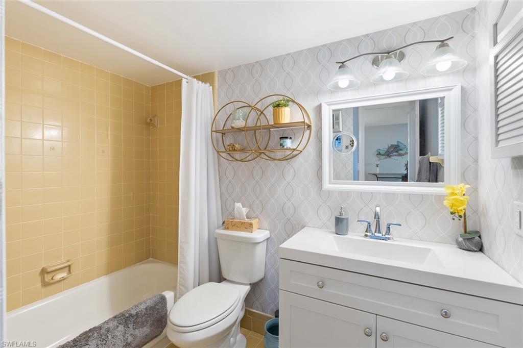 240 Palm Drive, Unit 481 Naples, FL 34112 - Photo 4 of 17 a bathroom with a sink a toilet and shower