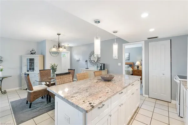 a kitchen with granite countertop sink and refrigerator