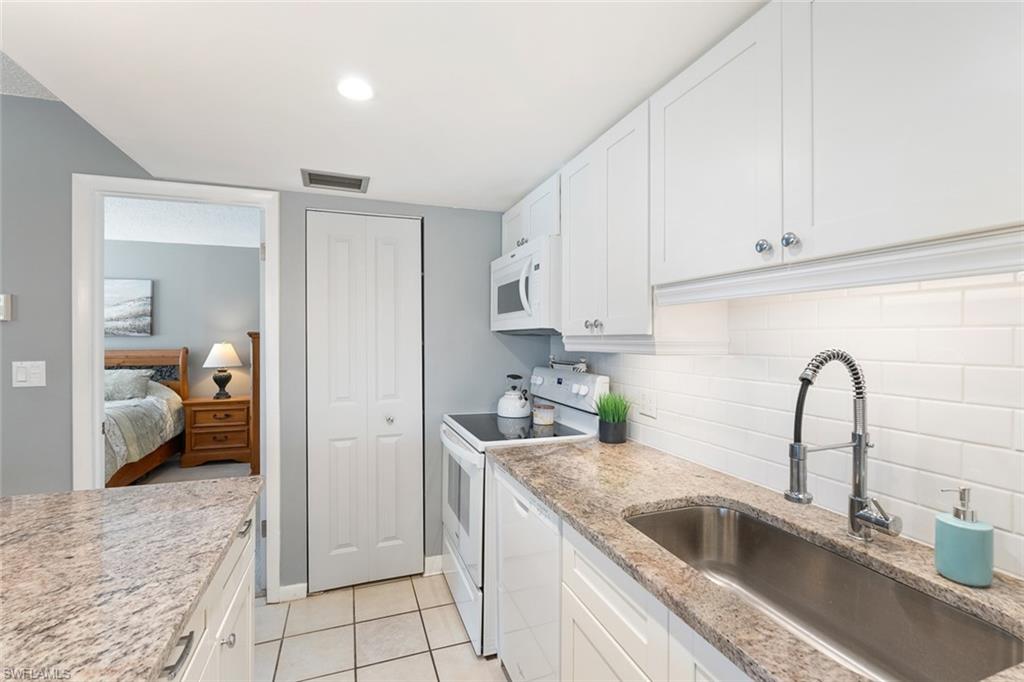 240 Palm Drive, Unit 481 Naples, FL 34112 - Photo 7 of 17 a kitchen with a sink and cabinets