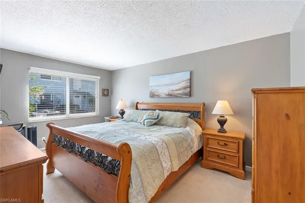 a bedroom with bed and a window