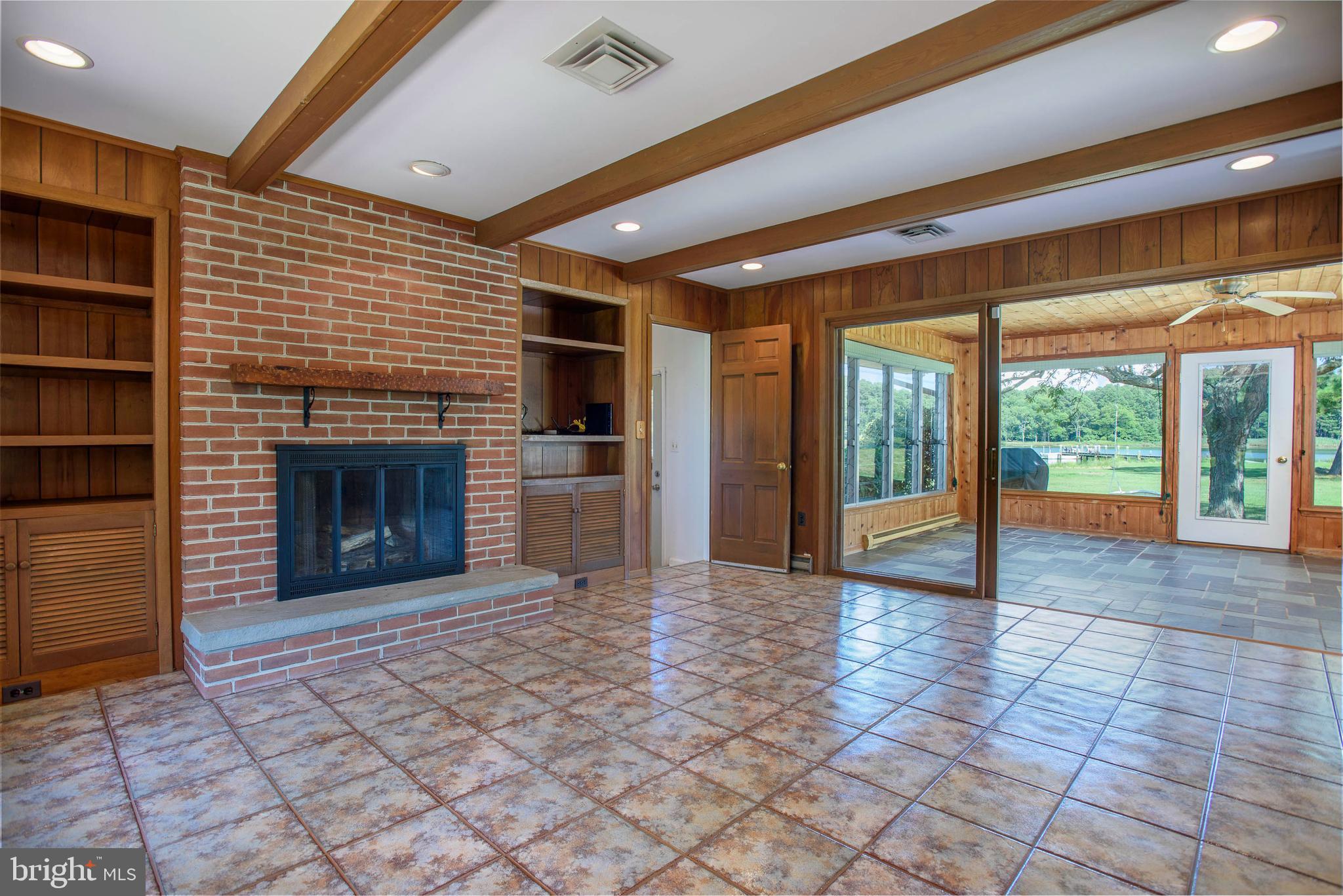 7221 Drum Point Road St. Michaels, MD 21663 - Photo 27 of 41 family room w/FP and opening to sunroom