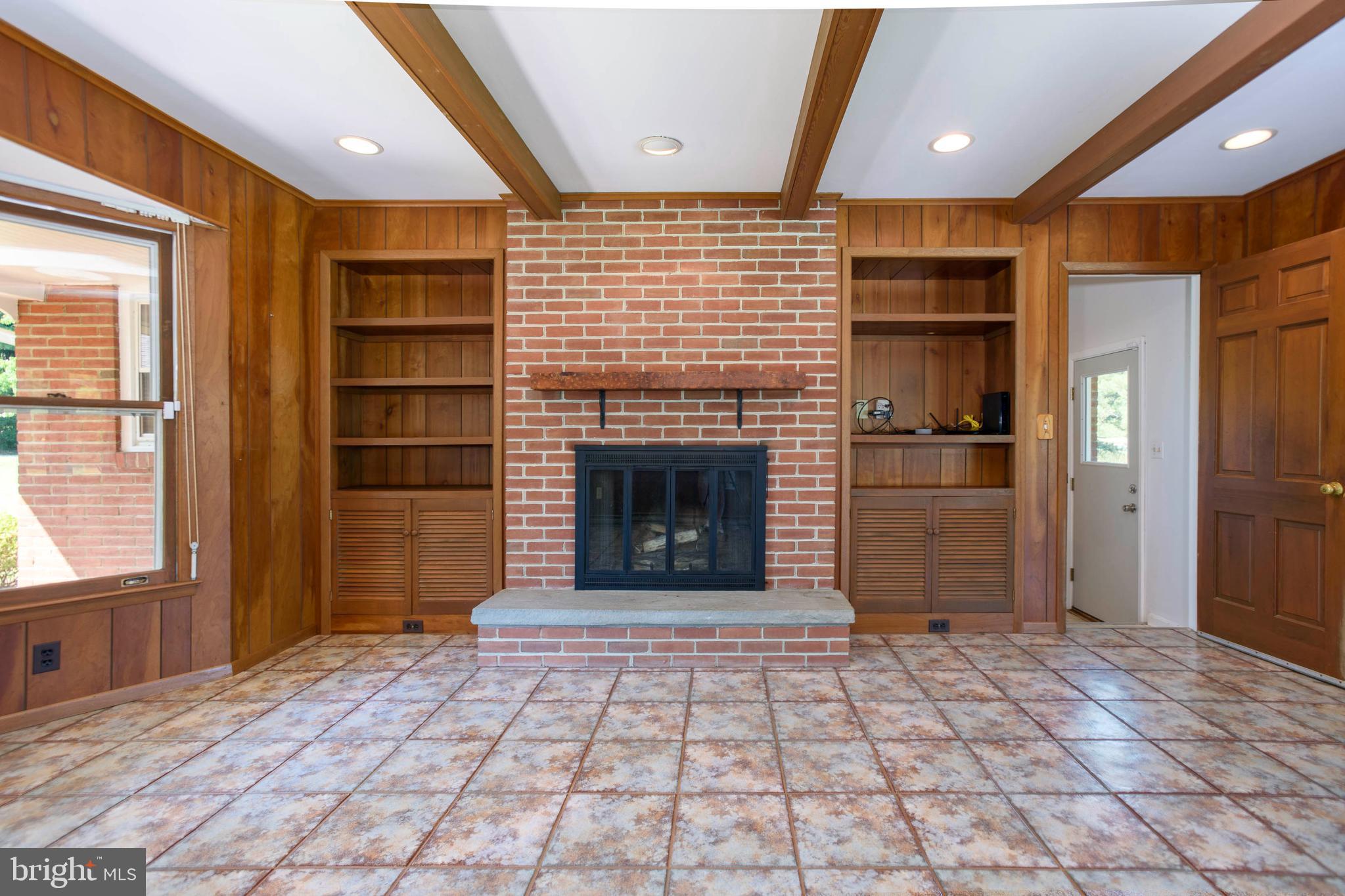 7221 Drum Point Road St. Michaels, MD 21663 - Photo 29 of 41 Family room bookcases and wood burning FP