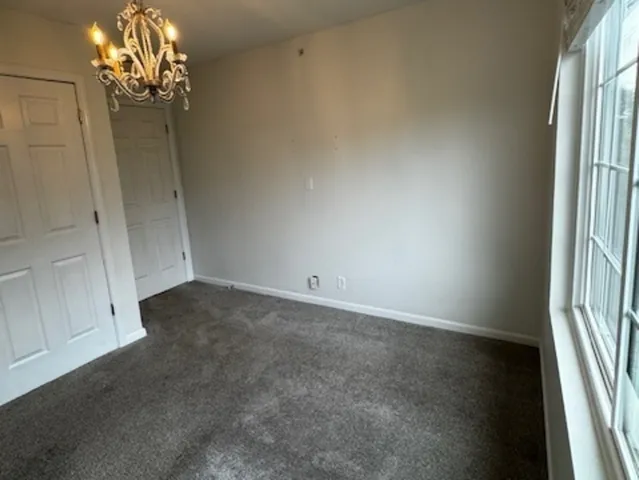 a view of a chandelier in big room and chandelier