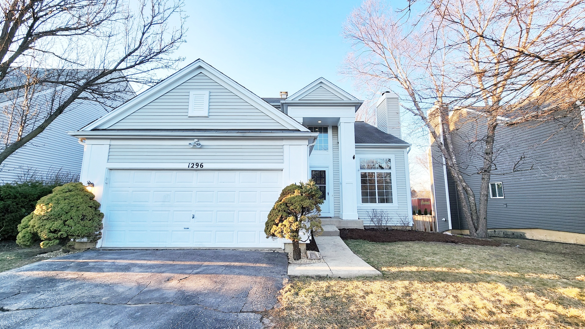 1296 Spaulding Road Bartlett, IL 60103 - Photo 1 of 37 a view of a house with a yard and large tree