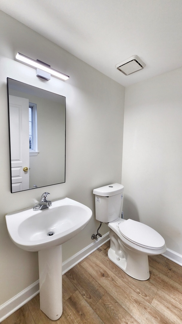 1296 Spaulding Road Bartlett, IL 60103 - Photo 12 of 37 a bathroom with a sink toilet and a mirror