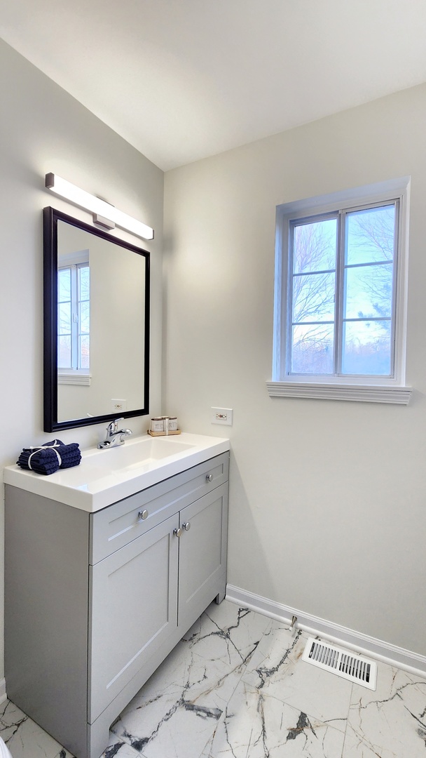 1296 Spaulding Road Bartlett, IL 60103 - Photo 19 of 37 a bathroom with a sink toilet and mirror