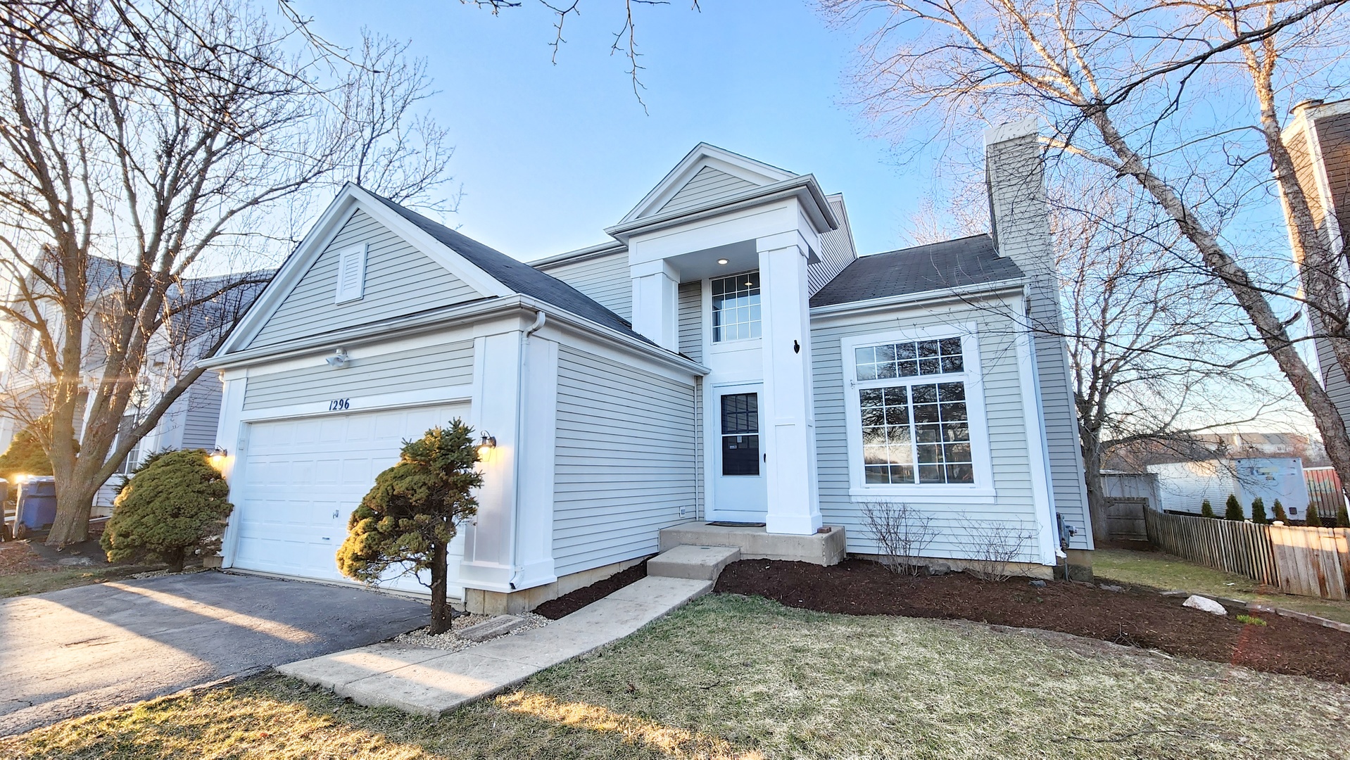 1296 Spaulding Road Bartlett, IL 60103 - Photo 2 of 37 a front view of a house with a yard and garage