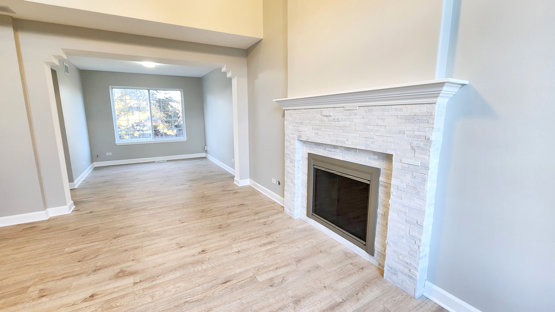 1296 Spaulding Road Bartlett, IL 60103 - Photo 5 of 37 a view of an empty room with wooden floor and a window